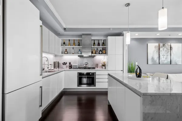 a kitchen with stainless steel appliances granite countertop a sink and cabinets