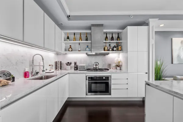 a kitchen with stainless steel appliances granite countertop a sink stove and cabinets