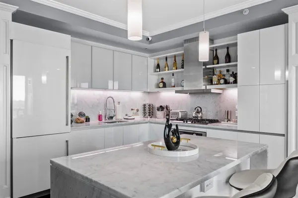 a kitchen with stainless steel appliances granite countertop a sink and a refrigerator