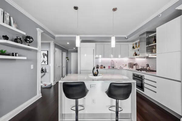 a kitchen with stainless steel appliances granite countertop a sink refrigerator and cabinets
