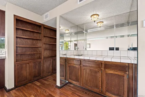 a kitchen with cabinets and wooden floor