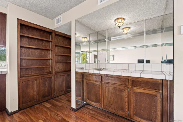 a kitchen with cabinets and wooden floor