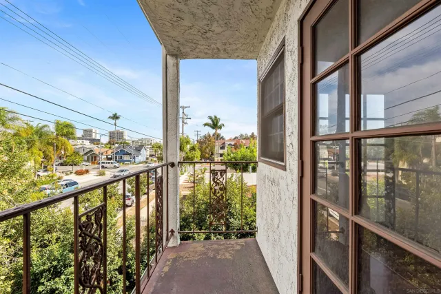 a view of a balcony with wooden floor
