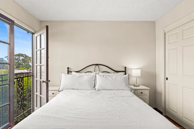 a bedroom with a large bed and a large window