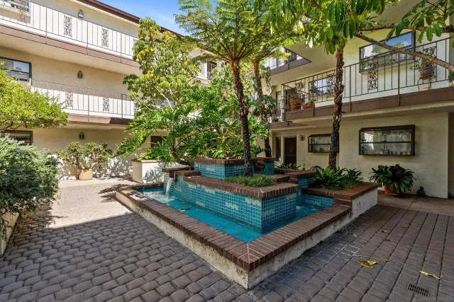 a view of a house with backyard sitting area and garden