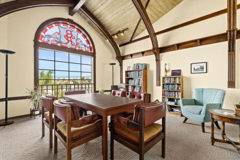 a view of a dining room with furniture and a window