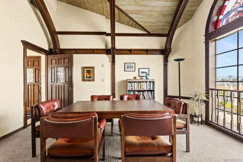a view of a dining room with furniture and a window