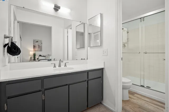 a bathroom with a double vanity sink toilet and shower