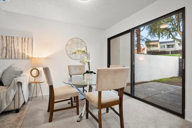 a dining room with furniture and a window