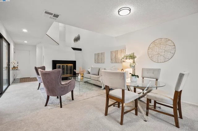 a living room with furniture a clock and a window