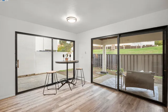 a view of a room with wooden floor and windows