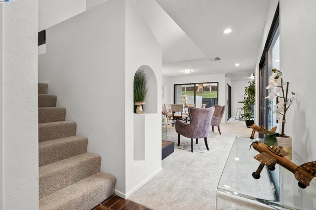 a view of a livingroom with furniture and floor to ceiling window