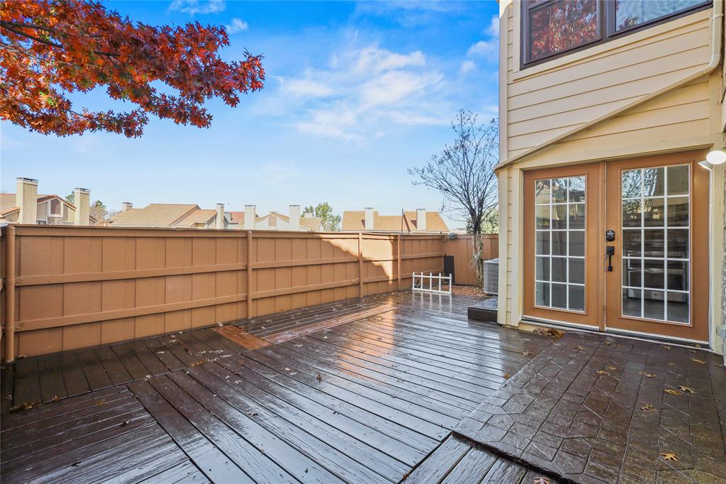 4288 Madera Road, Unit 4 Irving, TX 75038 - Photo 1 of 18 a view of a terrace with wooden floor and fence