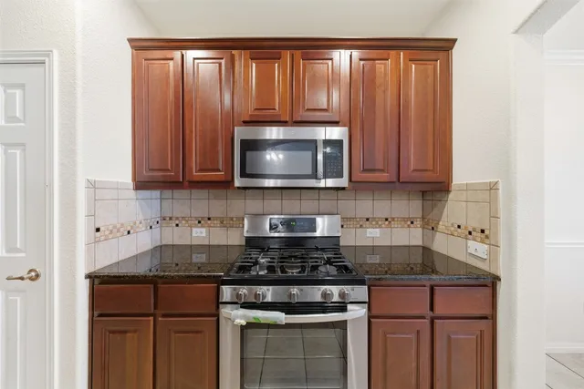 a bathroom with a sink a toilet a mirror and shower