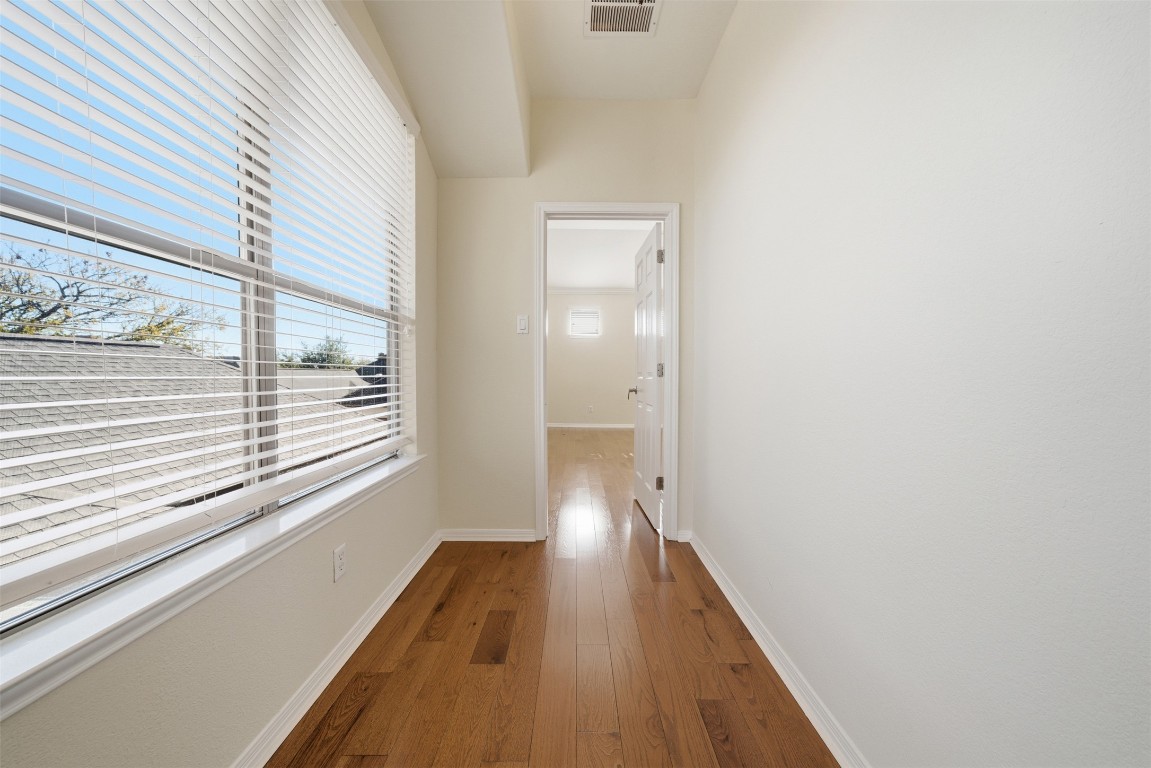 14100 Avery Ranch Boulevard, Unit 1502 Austin, TX 78717 - Photo 19 of 39 Hallway with dark wood-style flooring and baseboards