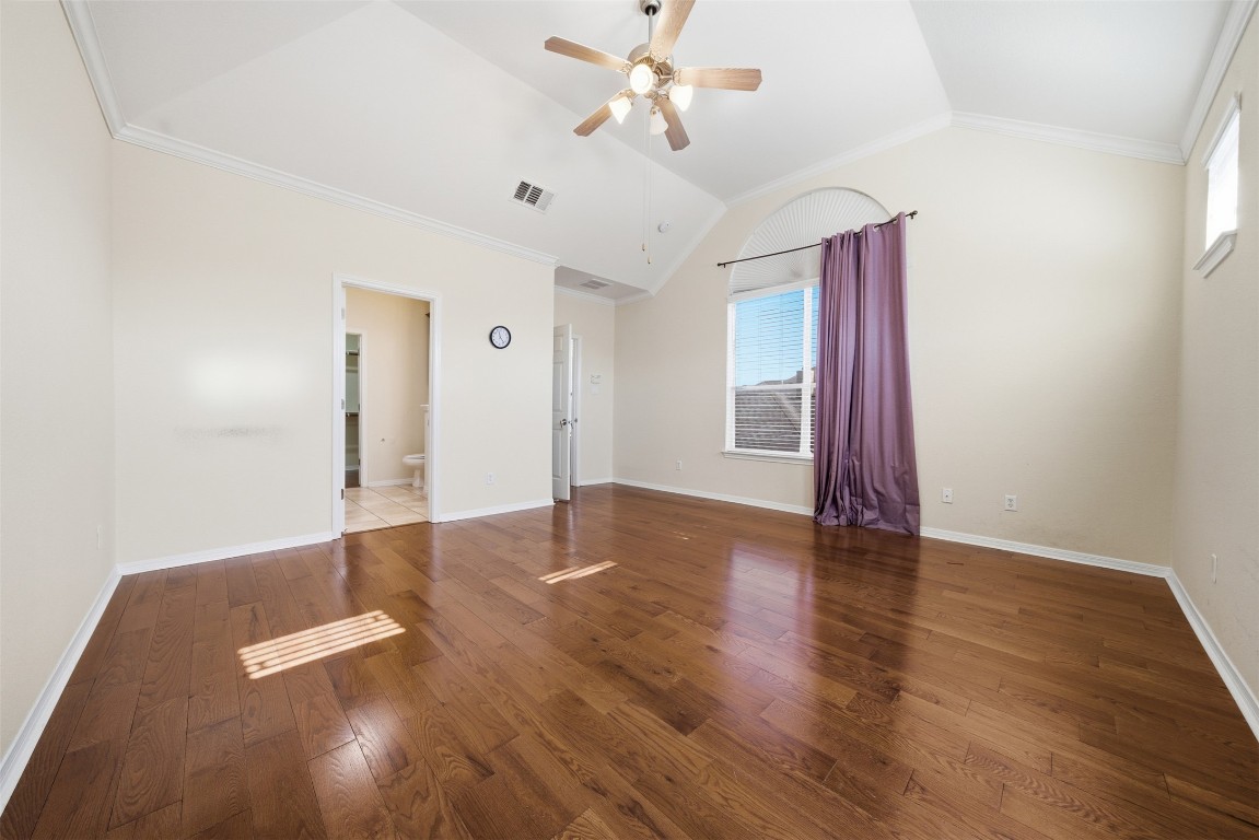 14100 Avery Ranch Boulevard, Unit 1502 Austin, TX 78717 - Photo 22 of 39 Spare room featuring dark wood-style flooring, ceiling fan, crown molding, and lofted ceiling