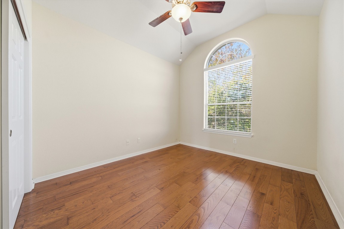 14100 Avery Ranch Boulevard, Unit 1502 Austin, TX 78717 - Photo 23 of 39 Spare room with vaulted ceiling, hardwood / wood-style flooring, and a ceiling fan