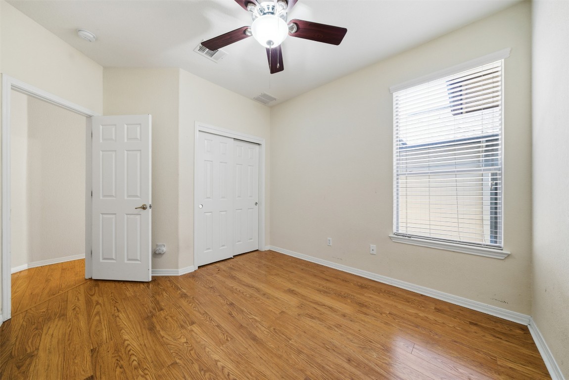 14100 Avery Ranch Boulevard, Unit 1502 Austin, TX 78717 - Photo 25 of 39 Unfurnished bedroom featuring a ceiling fan, a closet, and light wood finished floors