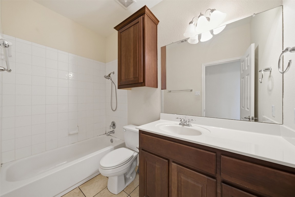 14100 Avery Ranch Boulevard, Unit 1502 Austin, TX 78717 - Photo 30 of 39 a bathroom with a sink a toilet a mirror and shower