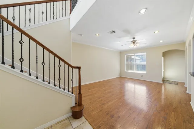 a view of a room with wooden floor and white walls