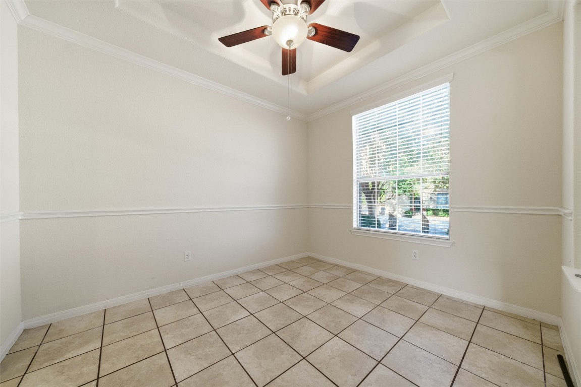 14100 Avery Ranch Boulevard, Unit 1502 Austin, TX 78717 - Photo 7 of 39 Spare room featuring a raised ceiling, ornamental molding, light tile patterned floors, and ceiling fan