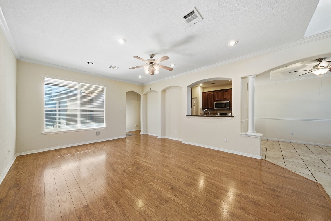 14100 Avery Ranch Boulevard, Unit 1502 Austin, TX 78717 - Photo 10 of 39 a view of an empty room with a window and wooden floor