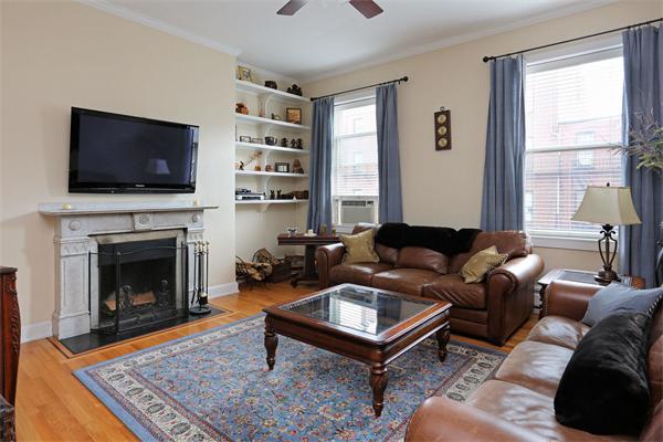 271 Beacon Street, Unit 6 Boston, MA 02116 - Photo 2 of 7 a living room with furniture a flat screen tv and a fireplace