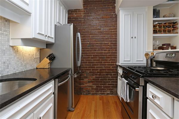 271 Beacon Street, Unit 6 Boston, MA 02116 - Photo 4 of 7 a kitchen with a sink stove and cabinets