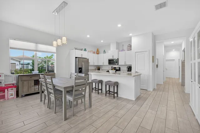 a living room with furniture and kitchen view