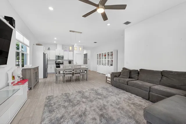 a bedroom with a large bed and a flat tv screen on dresser