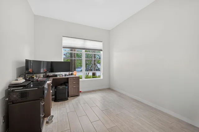 a view of a workspace with furniture and a flat screen tv