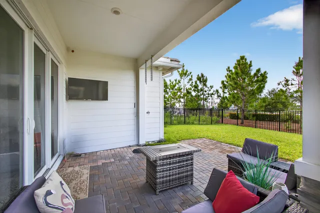 a view of a house with backyard and sitting area