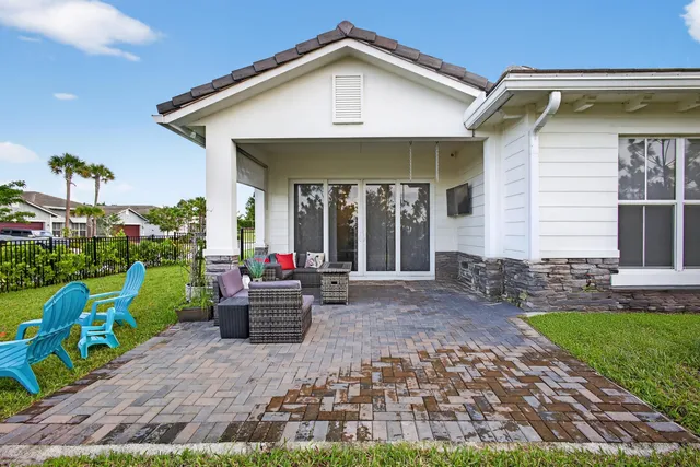 an aerial view of residential houses with outdoor space and swimming pool