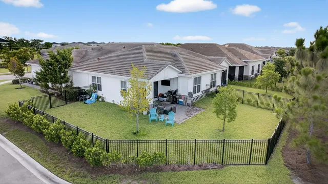 an aerial view of a house with a yard and lake view