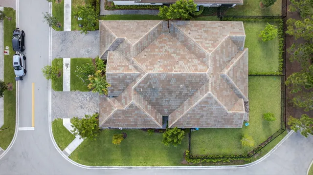 an aerial view of residential houses with outdoor space and swimming pool