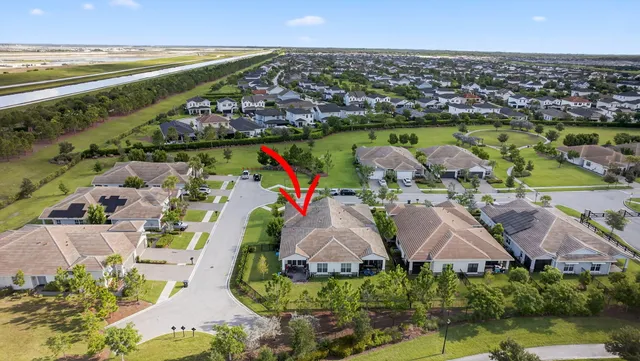 an aerial view of a house with yard swimming pool and outdoor seating