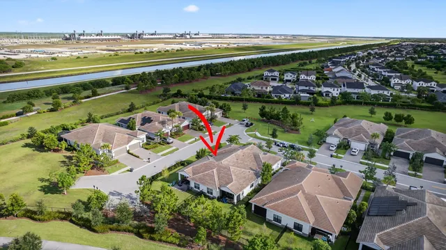 a view of a swimming pool with lawn chairs