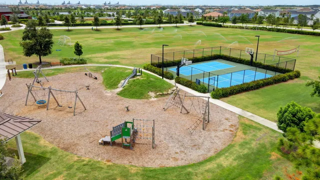a view of a park with a house in the background