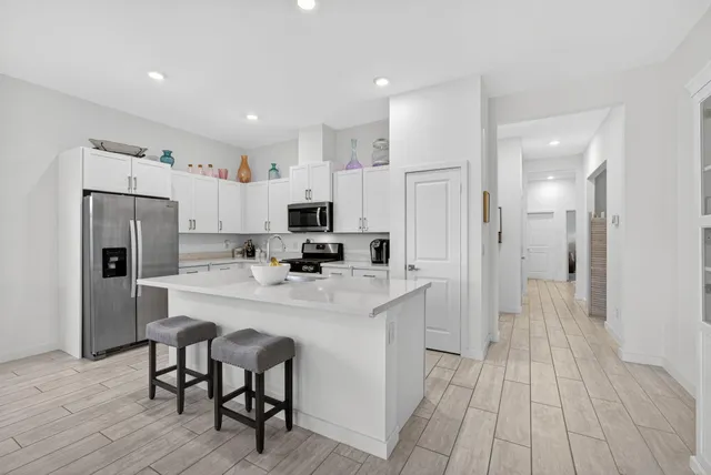 a dining room with furniture window and wooden floor