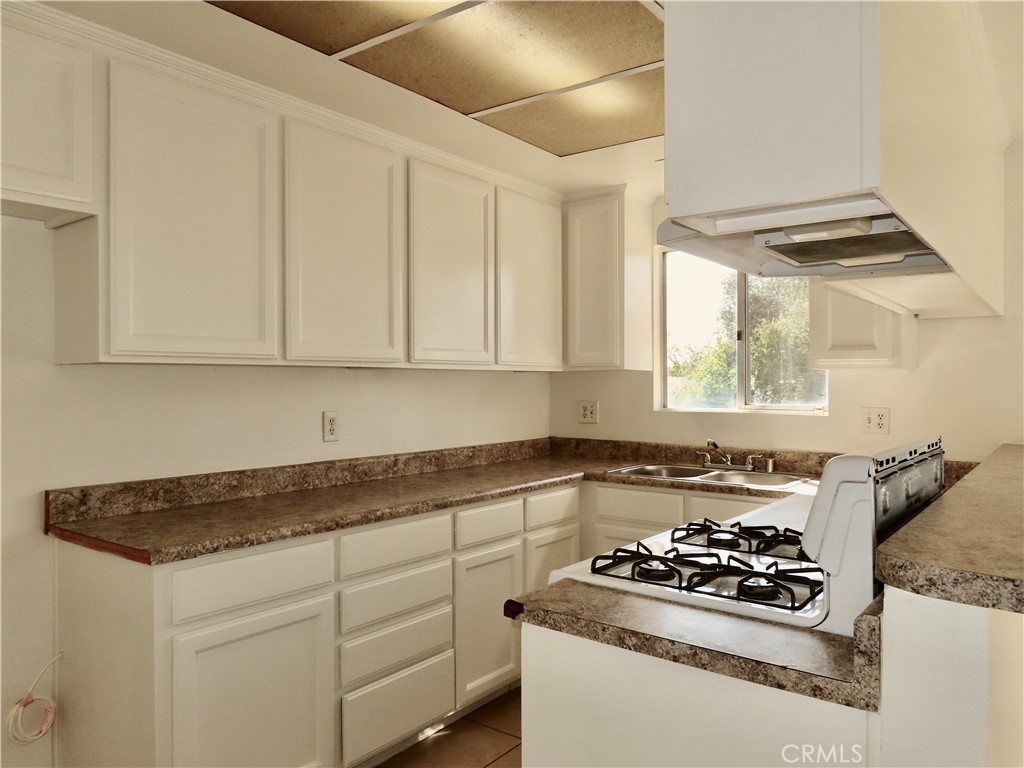 6149 La Sierra Avenue Riverside, CA 92505 - Photo 15 of 37 a white kitchen with sink and stove