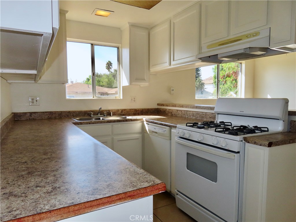 6149 La Sierra Avenue Riverside, CA 92505 - Photo 16 of 37 a kitchen with a stove a sink and a window