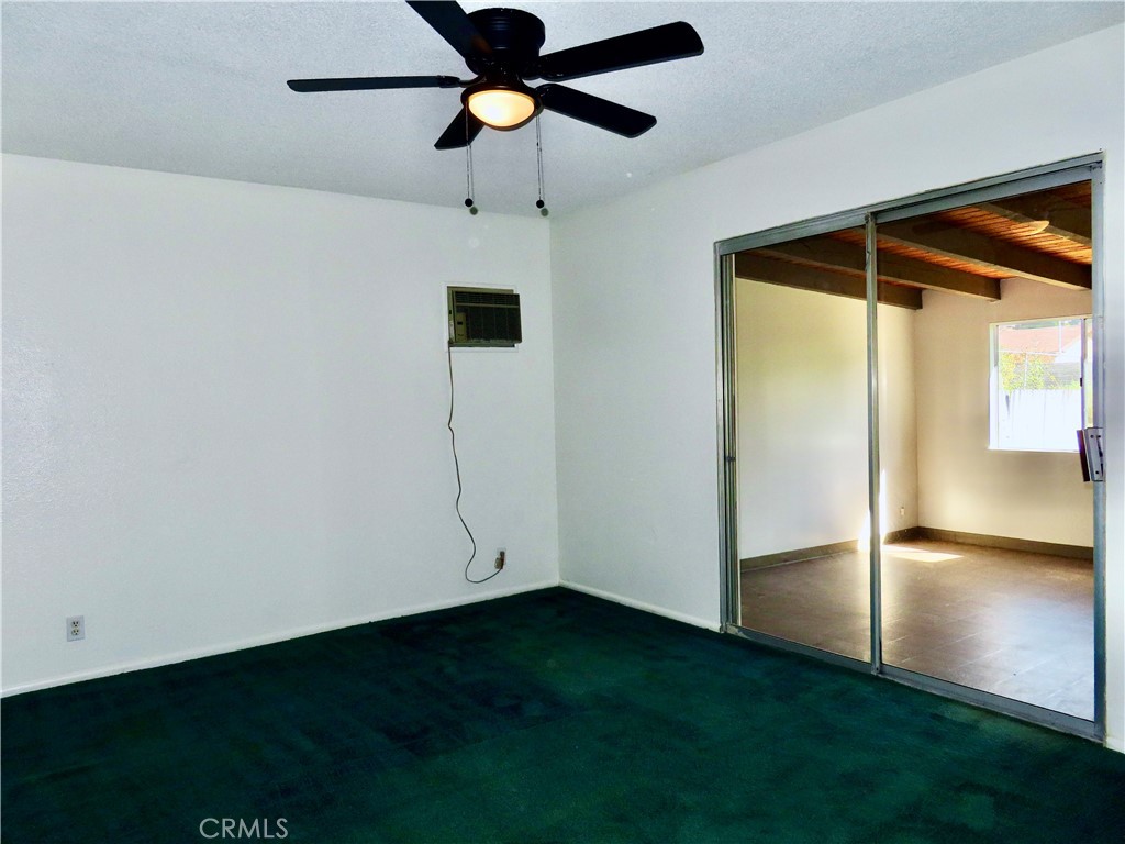 6149 La Sierra Avenue Riverside, CA 92505 - Photo 23 of 37 an empty room with a ceiling fan and a window