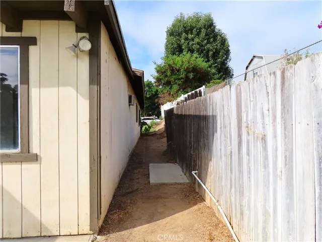 a backyard of a house with table and chairs