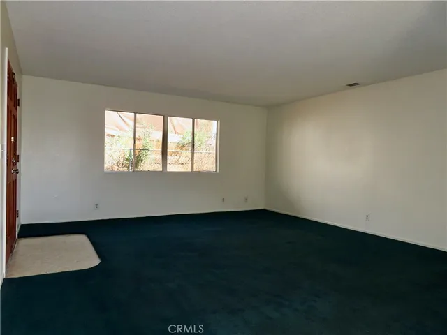 a view of a dining room with furniture and a chandelier fan