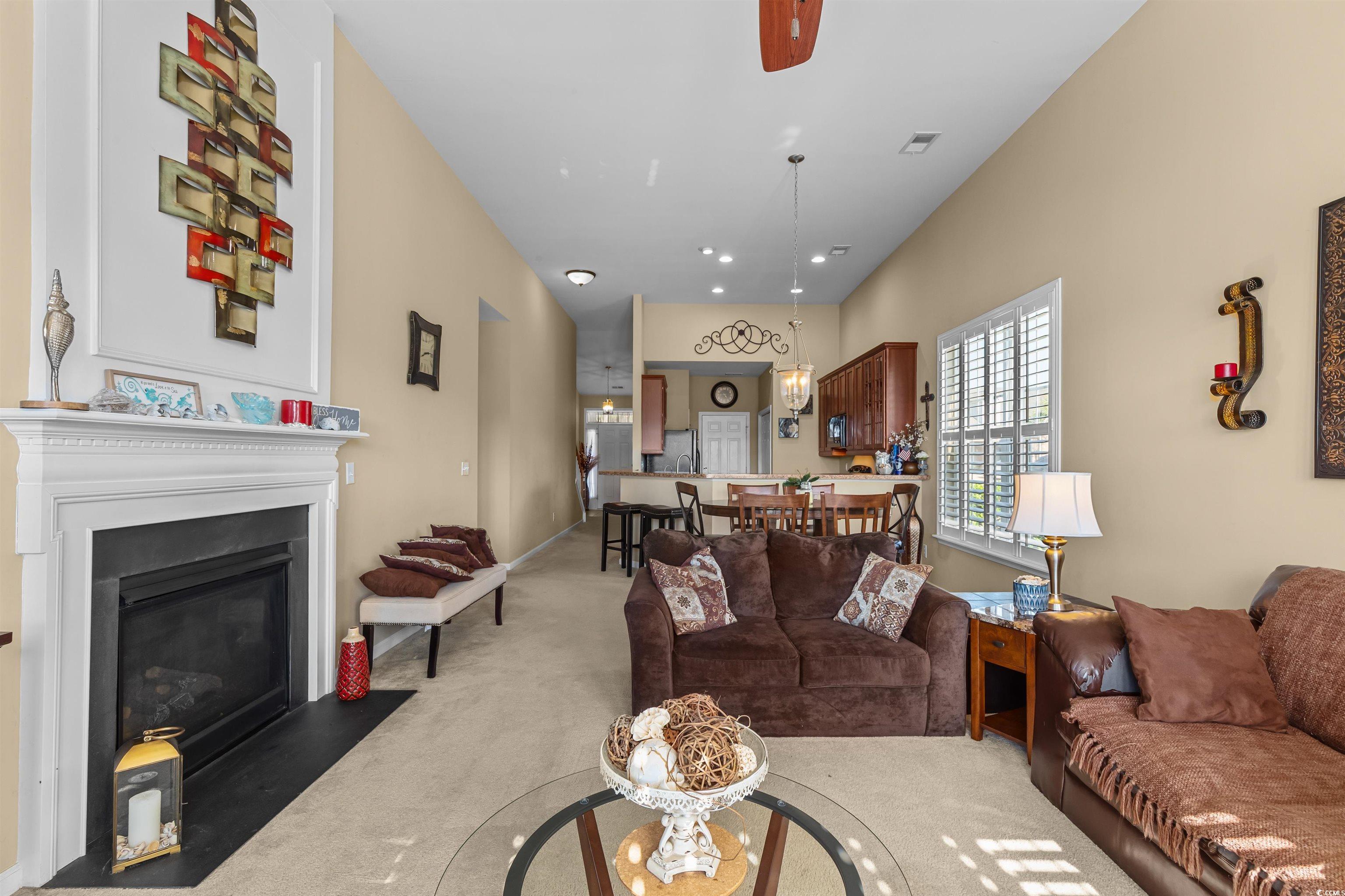 3233 Volterra Way, Unit 3233 Myrtle Beach, SC 29579 - Photo 17 of 40 Living room featuring light colored carpet, a glass covered fireplace, recessed lighting, and a ceiling fan