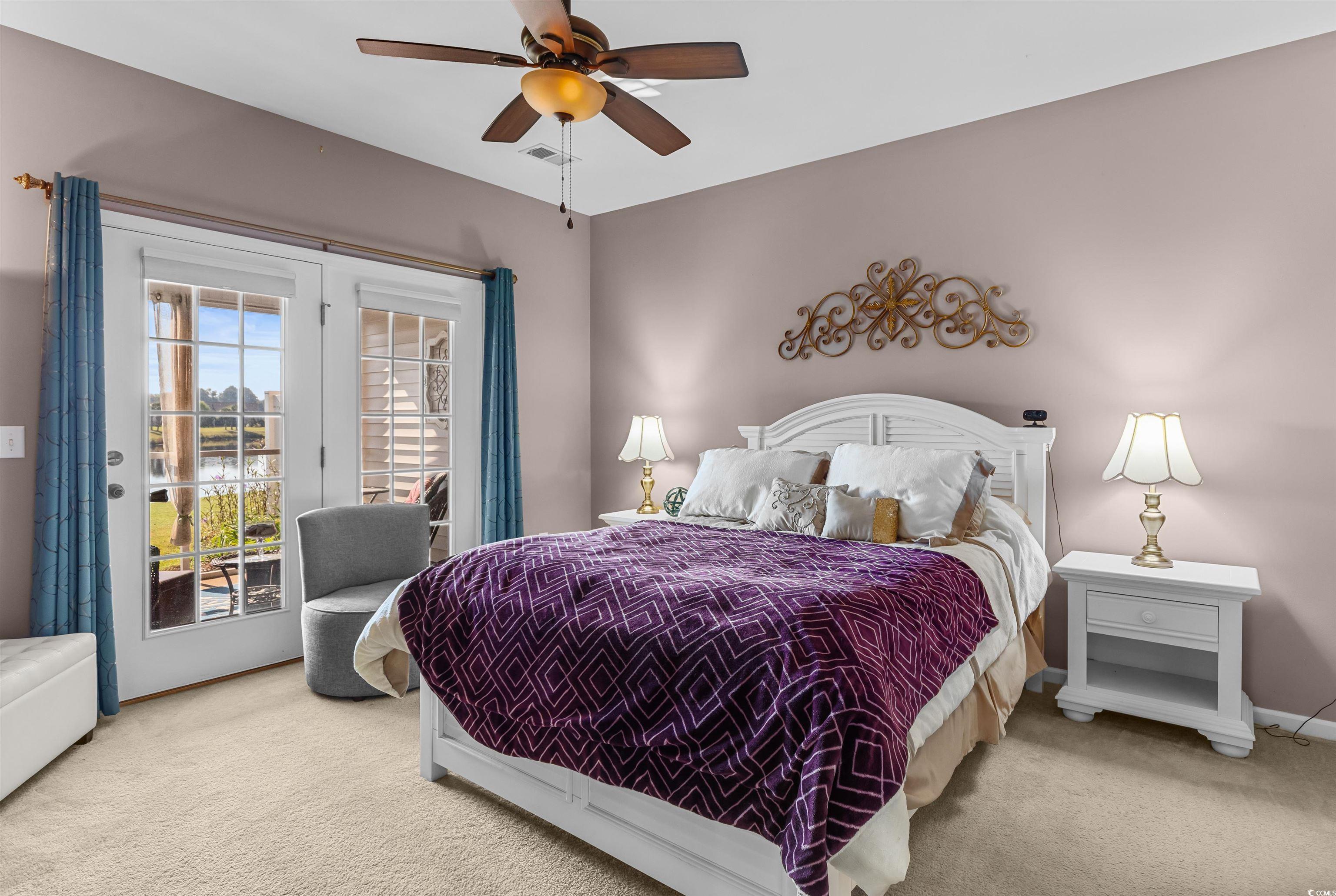 3233 Volterra Way, Unit 3233 Myrtle Beach, SC 29579 - Photo 19 of 40 Bedroom featuring access to exterior, carpet flooring, and ceiling fan