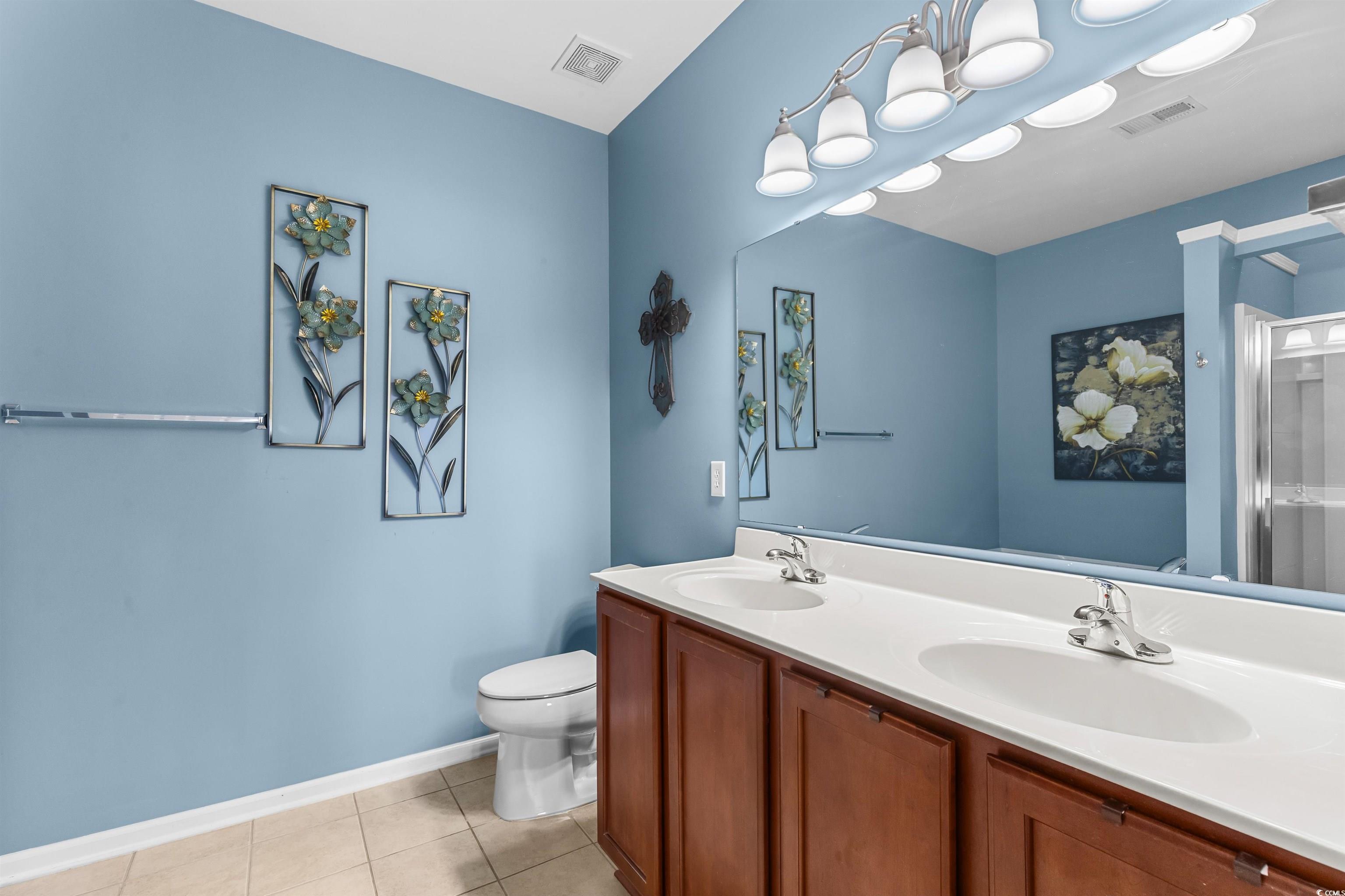 3233 Volterra Way, Unit 3233 Myrtle Beach, SC 29579 - Photo 21 of 40 Full bathroom featuring light tile patterned floors, double vanity, and a stall shower