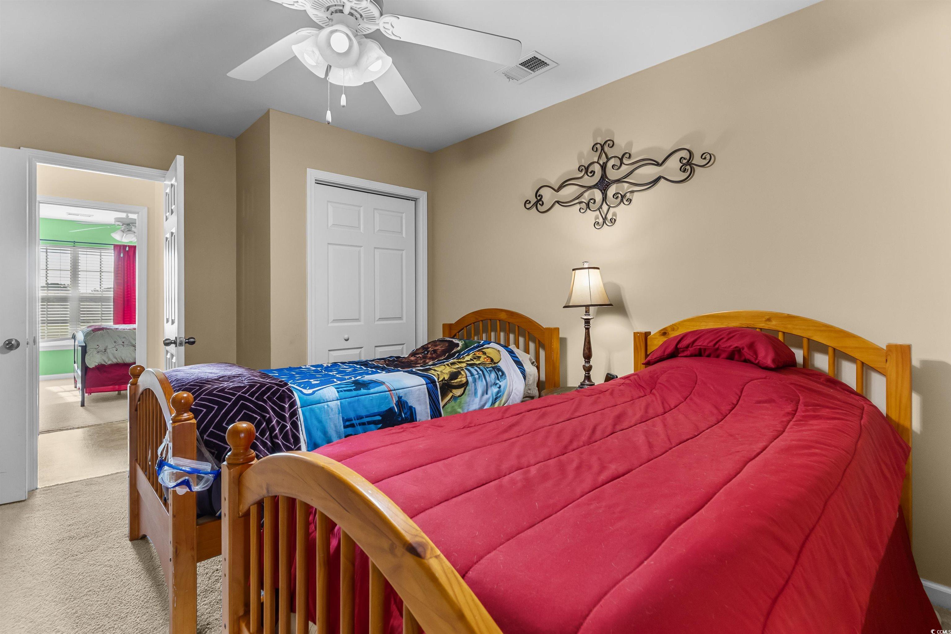 3233 Volterra Way, Unit 3233 Myrtle Beach, SC 29579 - Photo 26 of 40 Bedroom with carpet flooring, a closet, and ceiling fan