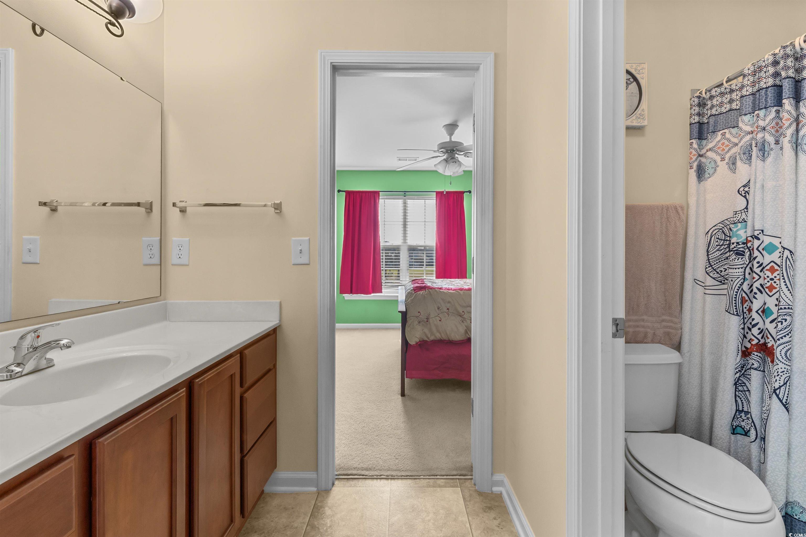 3233 Volterra Way, Unit 3233 Myrtle Beach, SC 29579 - Photo 27 of 40 Bathroom featuring ensuite bath, vanity, light tile patterned flooring, and ceiling fan