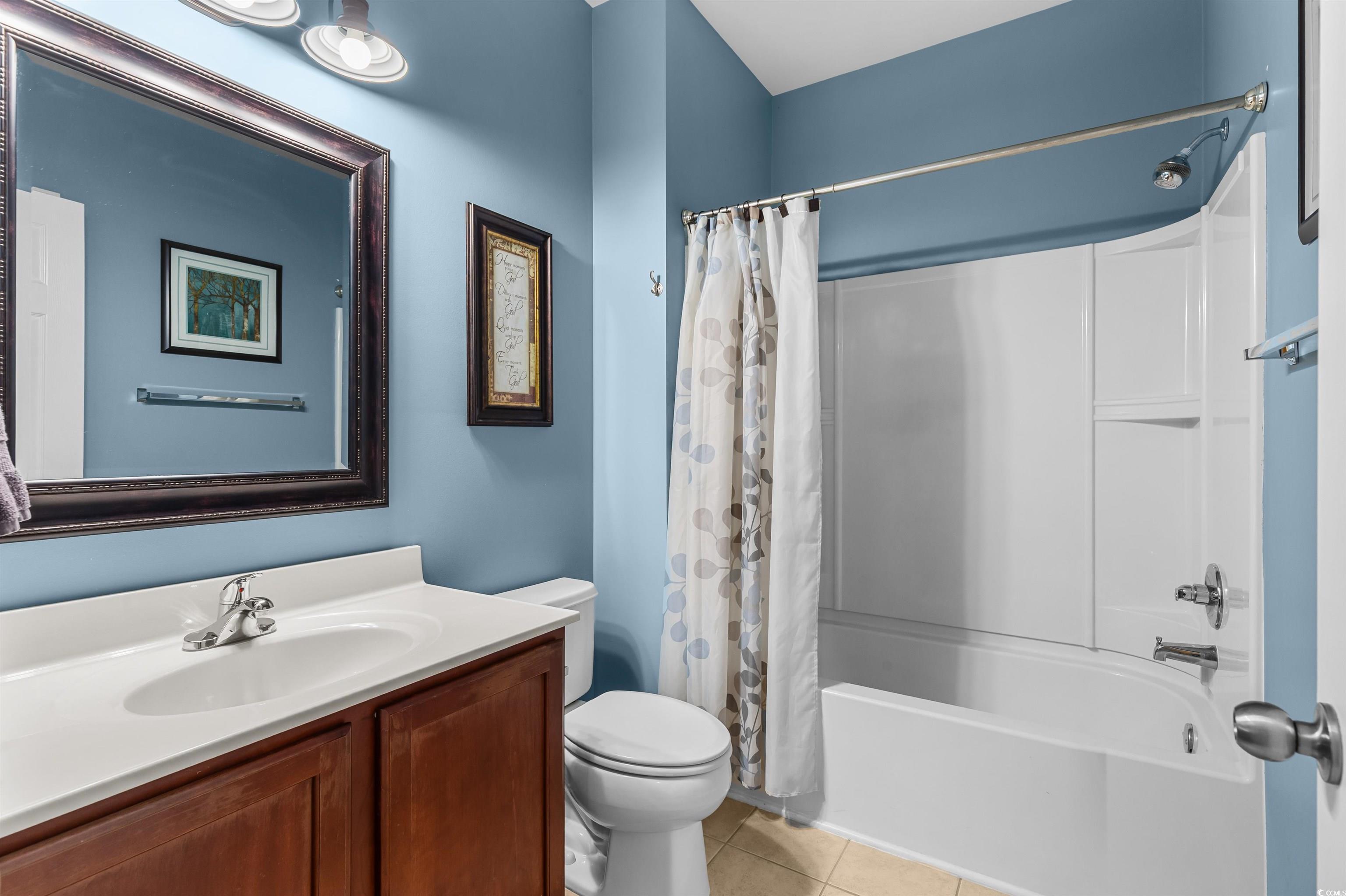 3233 Volterra Way, Unit 3233 Myrtle Beach, SC 29579 - Photo 8 of 40 Full bathroom with shower / bath combination with curtain, light tile patterned flooring, and vanity